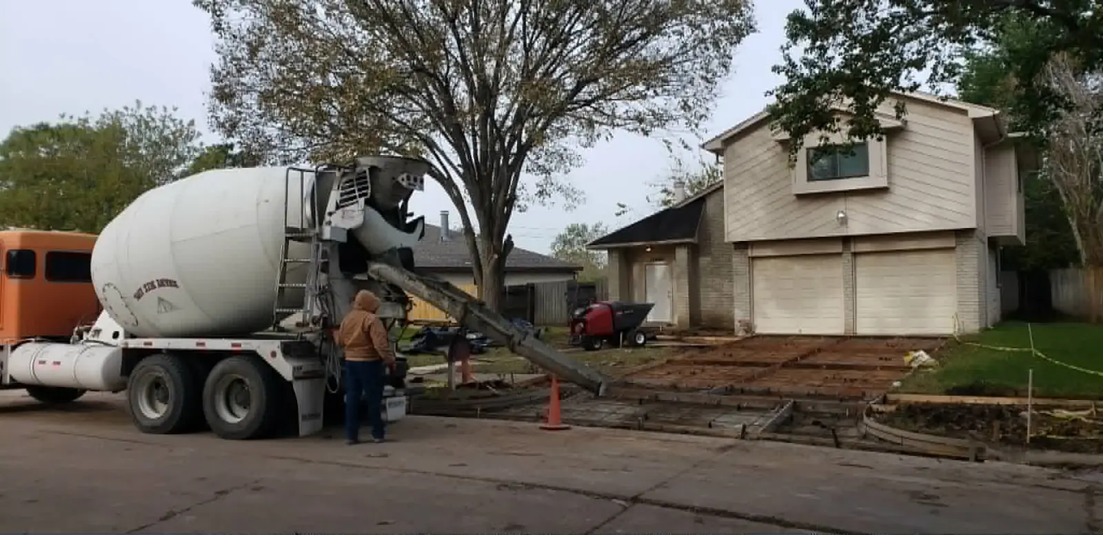 Concrete truck pouring a replacement driveway