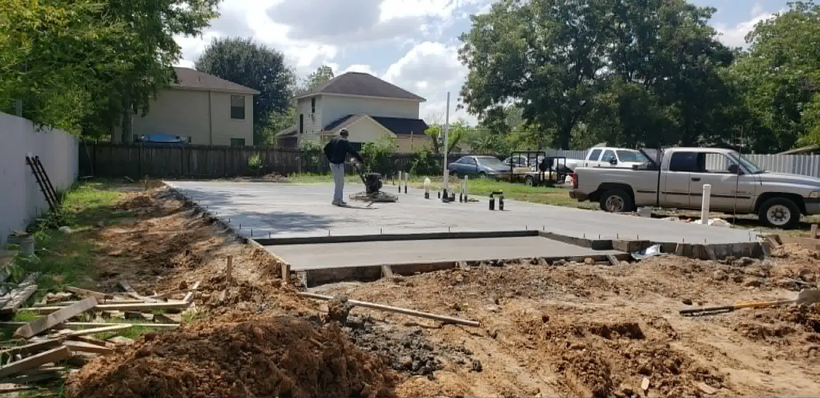 Crew power-trowel finishing a concrete foundation slab